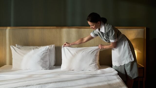 Making Bed in a Clean Modern Hotel Room