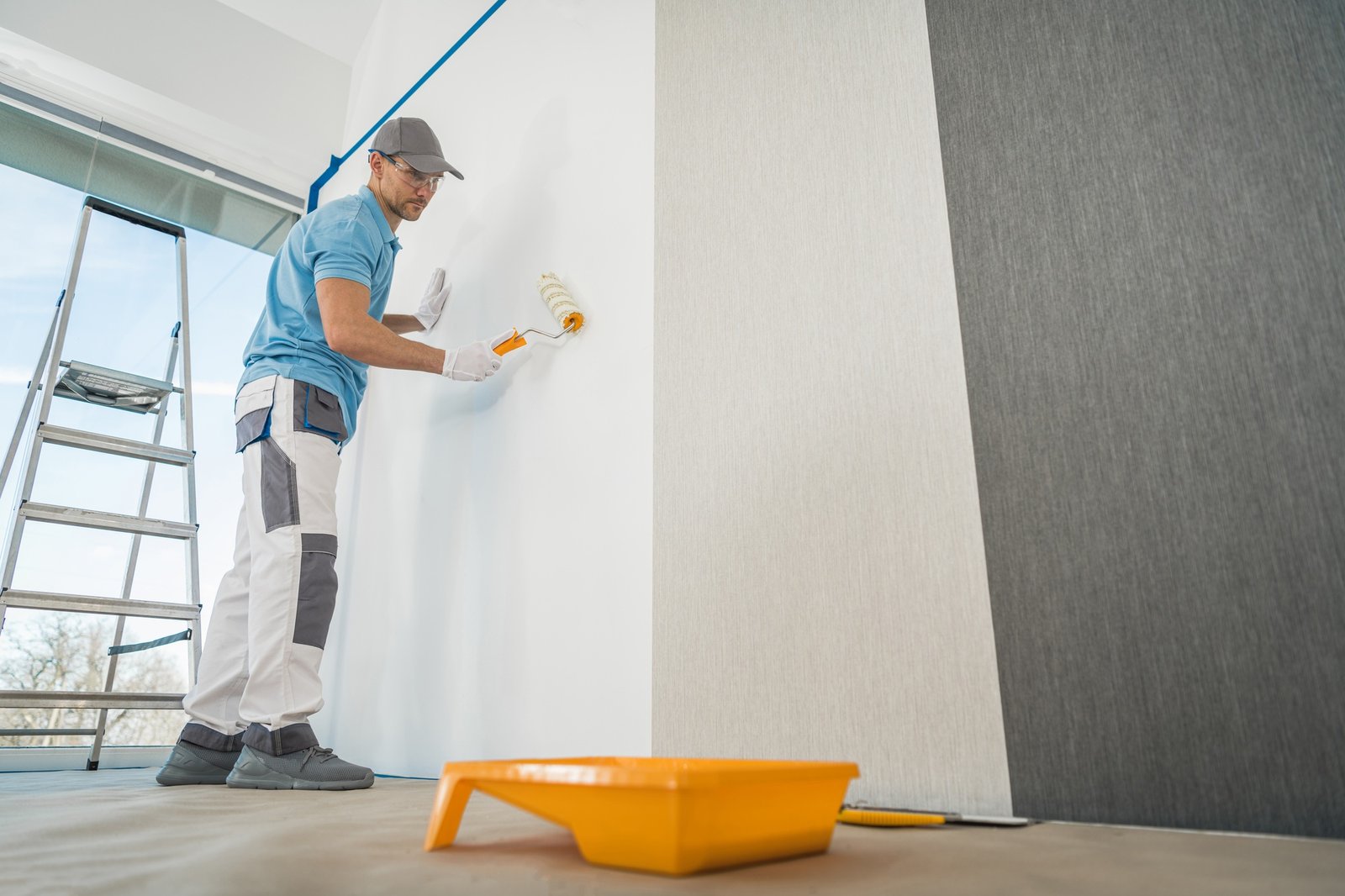 Men Applying Vinyl Wallpaper in a Room